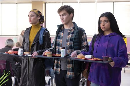 Nakia Bahadir, Bruno, and Kamala holding their lunch at school